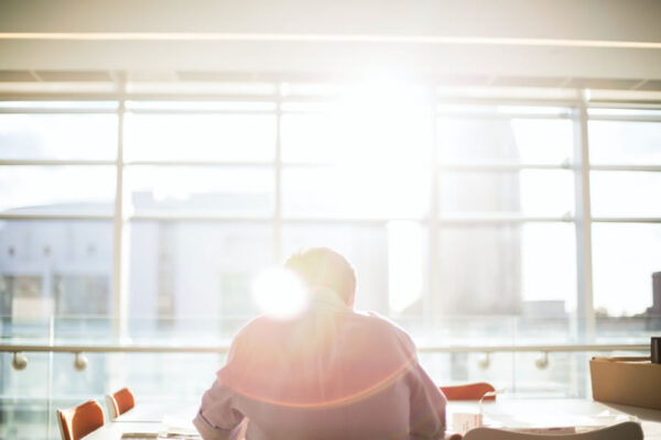 man-sitting-at-desk-with-light